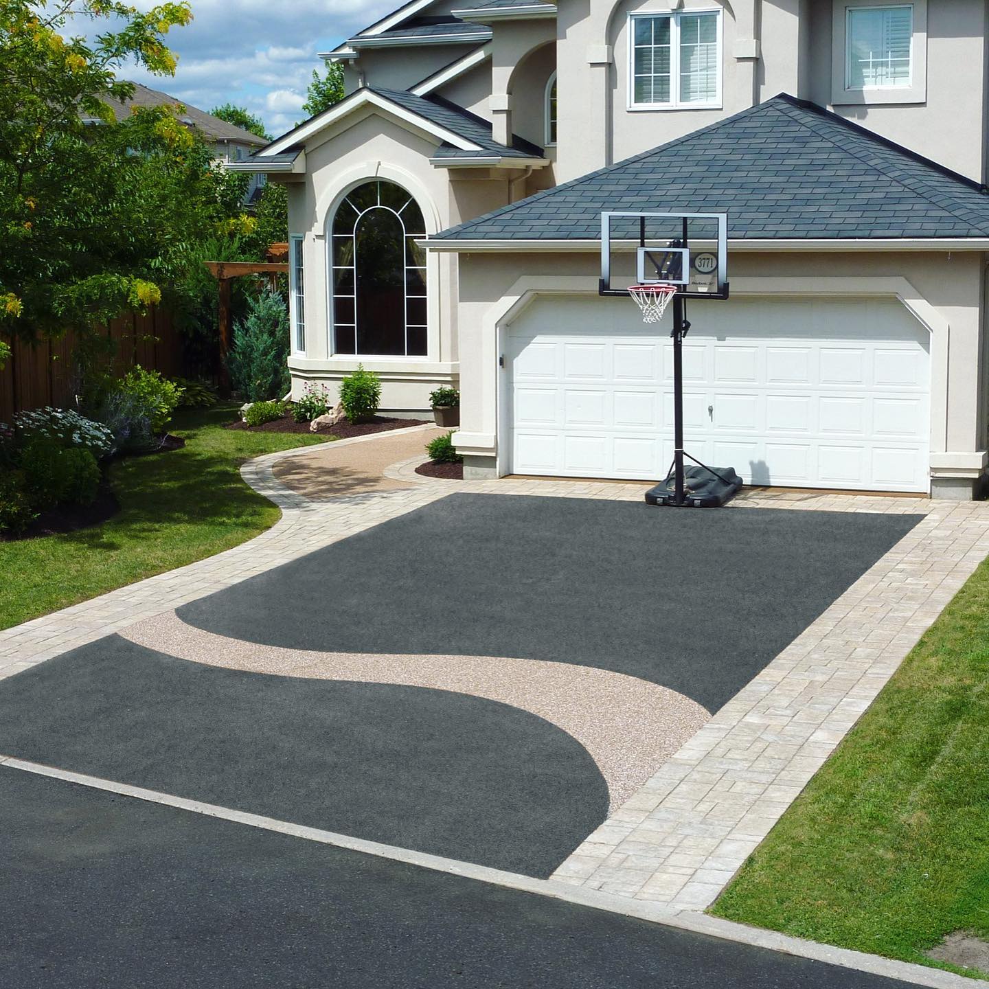 Rubber safety surfacing driveway with design.